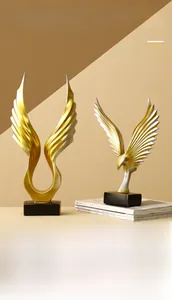Macro detail of Nordic resin angel wings statue with golden gradient and black base