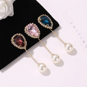 Set of three elegant teardrop crystal brooches with white pearls and gold pins