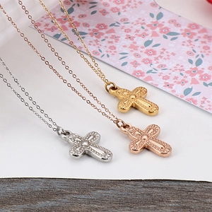 Three minimalist cross necklaces in gold, silver, and rose gold plating for women