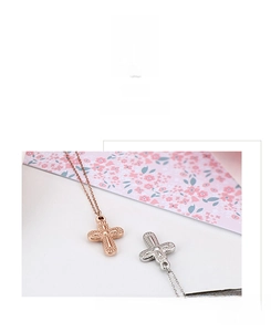 Macro shot of rose gold and silver cross pendants with intricate hollow dot textures
