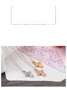 Detailed view of textured cross pendants in silver, gold, and rose gold metal finishes