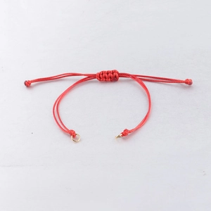 Detail of red 0.8mm waxed cord braided adjustable bracelet with gold rings