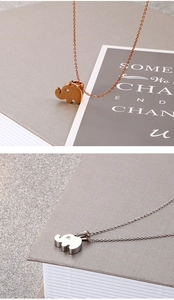 Detailed view of elephant pendants in rose gold and silver finish with small gemstones