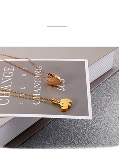 Detailed macro view of elephant pendants in rose gold and gold finish with crystal eye