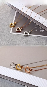 Detailed view of heart pendants in gold, rose gold, and silver with cubic zirconia