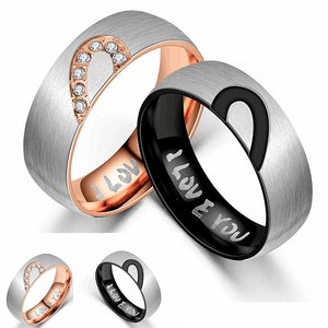 Detailed macro view of heart couple rings with I LOVE YOU engraving and cubic zirconia