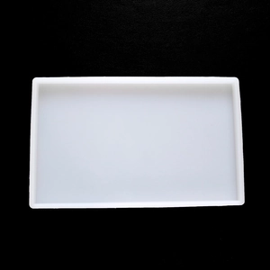 Macro view of a rectangular semi-transparent silicone resin mold on a black textured surface