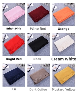 Collage of thick faux cashmere scarves in nine vibrant colors with tassel detail edges