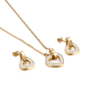 Elegant gold heart jewelry set including a necklace and earrings with sparkling crystals