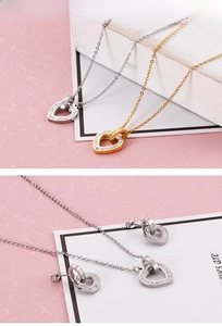 Close-up of heart-shaped diamond necklaces and earrings in silver and gold sets