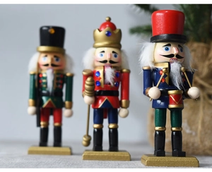 Close-up of three 15cm wooden nutcracker soldiers in red green and blue uniforms