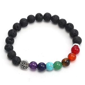 Detailed close-up of a black lava rock bracelet featuring colorful chakra beads and a tree of life