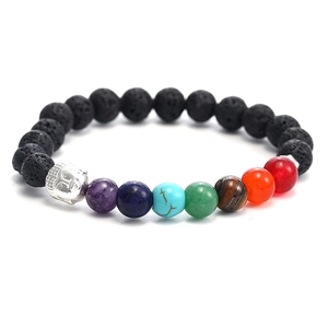 Macro detail of natural lava stone beads with seven chakra colors and a silver Buddha head