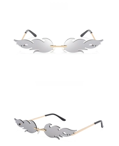 Macro detail of silver flame-shaped rimless sunglasses with reflective mirrored lenses