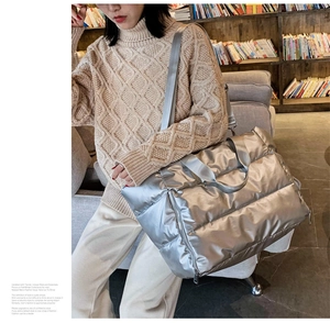 Silver padded fitness tote bag shown being worn by a model in a library setting