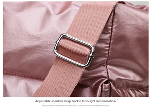 Detail of adjustable silver buckle and glossy quilted fabric on pink fitness bag
