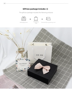 Three-piece jewelry gift set with black ribbon box, white paper bag, and greeting card