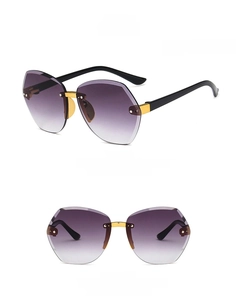 Detail view of rimless children's sunglasses with purple gradient lenses and gold bridge