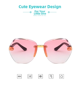 Detail of rimless polygon kids sunglasses with pink gradient lenses and gold metal bridge