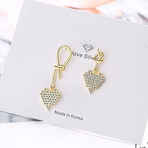 Elegant asymmetrical heart earrings in gold finish with sparkling pavé crystals