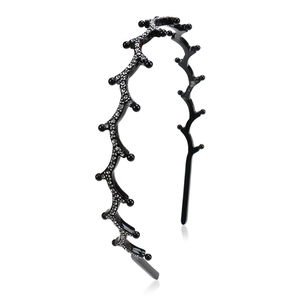 Detail of wavy branch headband with black beads and sparkling rhinestones on white background
