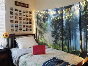 Nordic Christmas tree wall tapestry hanging in a cozy bedroom with minimalist forest design