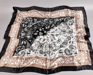 Detailed close-up showing the glossy texture and paisley pattern of the square silk scarf