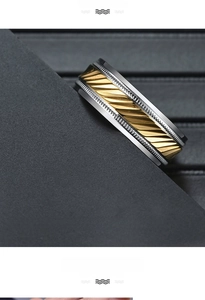 Macro shot of titanium ring with three-color bands and diagonal knurled texture