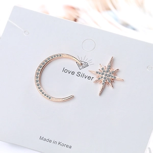 Asymmetric moon and star stud earrings in rose gold with shimmering cubic zirconia stones
