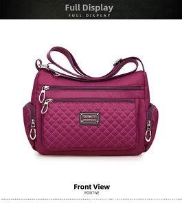 Detail of purple waterproof nylon bag with quilted diamond stitching and zip pockets