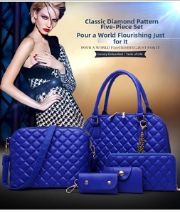 Detail view of royal blue quilted handbag 5-piece set with elegant golden hardware