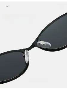 Detail of adjustable silicone nose pads on black matte metal oval frame sunglasses