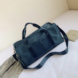 Detail of navy blue nylon fitness bag with waterproof fabric and sturdy handles