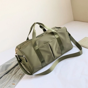 Detail of army green nylon fitness bag with waterproof dual pockets and sturdy handles