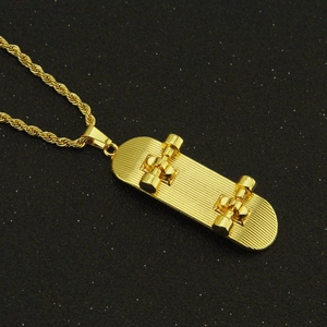 Macro detail of a golden skateboard pendant featuring rich textures on a twisted rope chain
