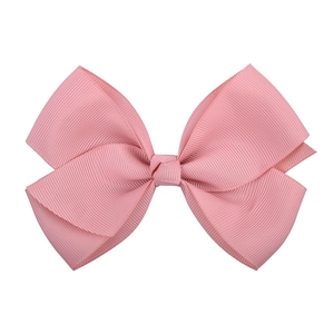 Detailed close-up of pink grosgrain ribbon bow hair clip with textured ribbed fabric