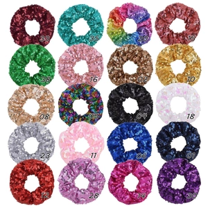 Flat lay of 20 colors sparkly sequin hair scrunchies set in various bright metallic shades