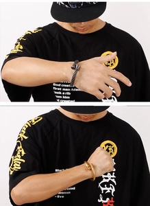 Detail of twisted cable texture on gold and gun black open bangles for men