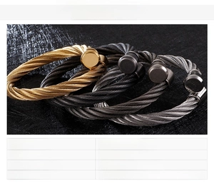 Detail of twisted cable stainless steel C-shaped bracelets in gold, silver, and black finishes