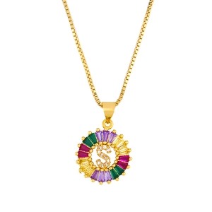 Detail of 18K gold letter S pendant with multi-colored gemstones and cubic zirconia