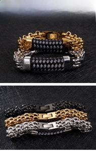 Detail of multi-layer men's stainless steel bracelet with cuban links and braided rope