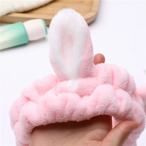 Plush pink bunny ear headband for face washing made of soft coral fleece material