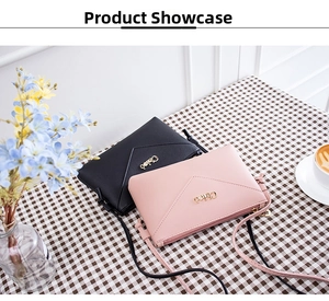 Detail view of black and pink PU leather crossbody bags with V-shaped stitching and gold logo