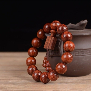 Detailed macro shot of 15mm sandalwood prayer beads with square plaque and gourd charms