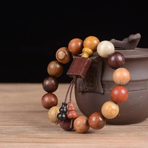 Detail of 15mm multi-wood prayer bead bracelet with square pendant on teapot