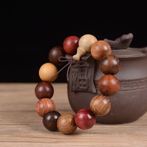 Detailed close-up of 18mm multi-colored wooden prayer beads on a traditional teapot