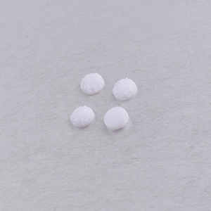 Macro detail of 8mm round white resin druzy stones with textured starry crystal surface
