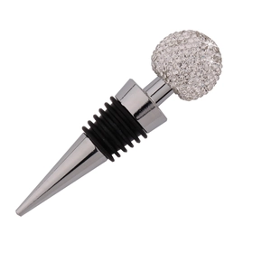Macro detail of a crystal ball wine stopper with silver metal and black rubber seals