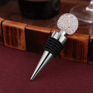 Detail of sparkling crystal wine stopper with silver metal base on a rustic wooden rack
