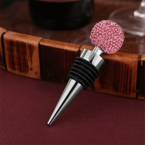 Detailed view of a zinc alloy wine stopper with a sparkling pink rhinestone crystal ball